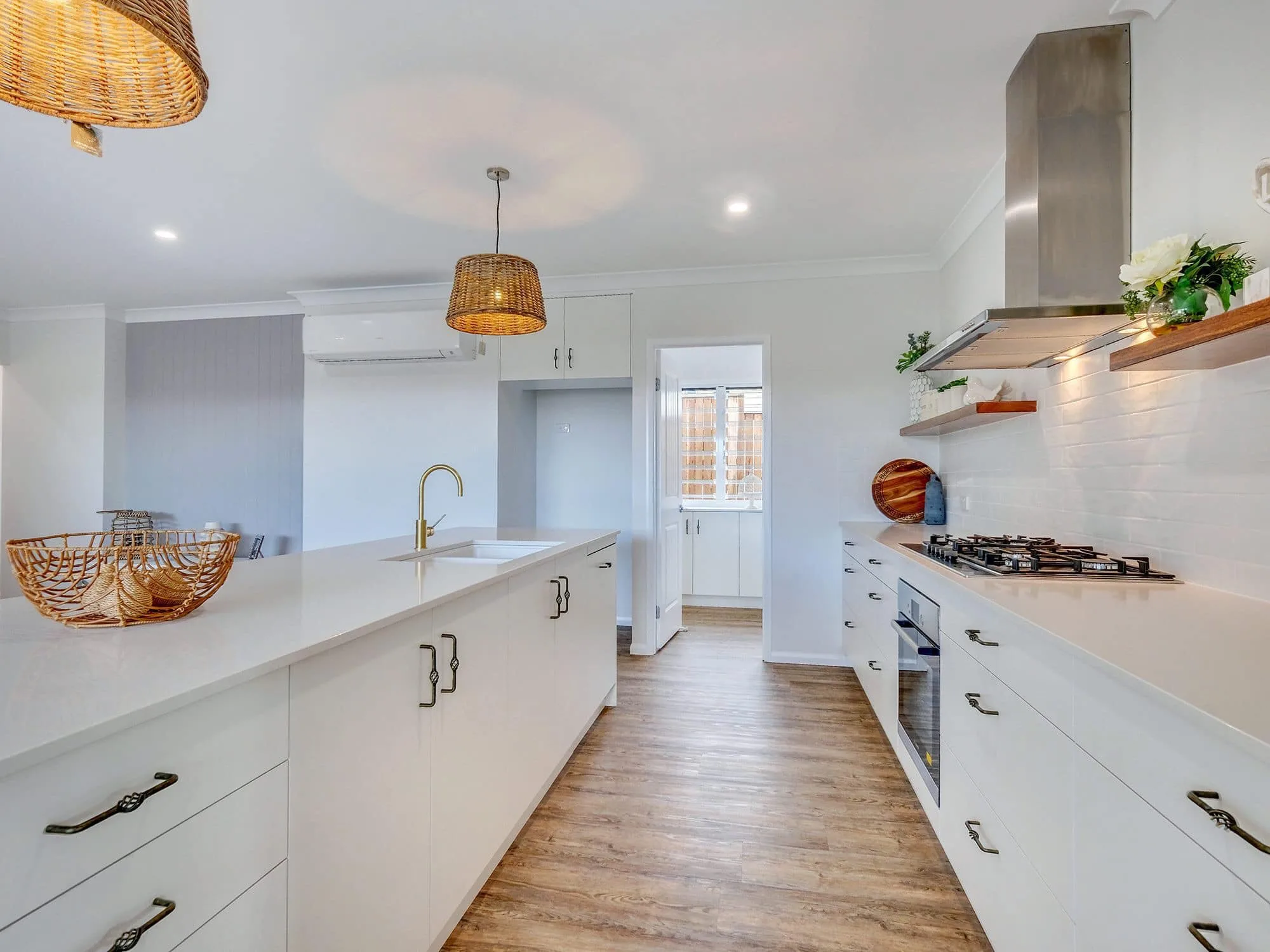Kitchen benchtop with gas cooktop and stone surface by MGH Cabinetmaking